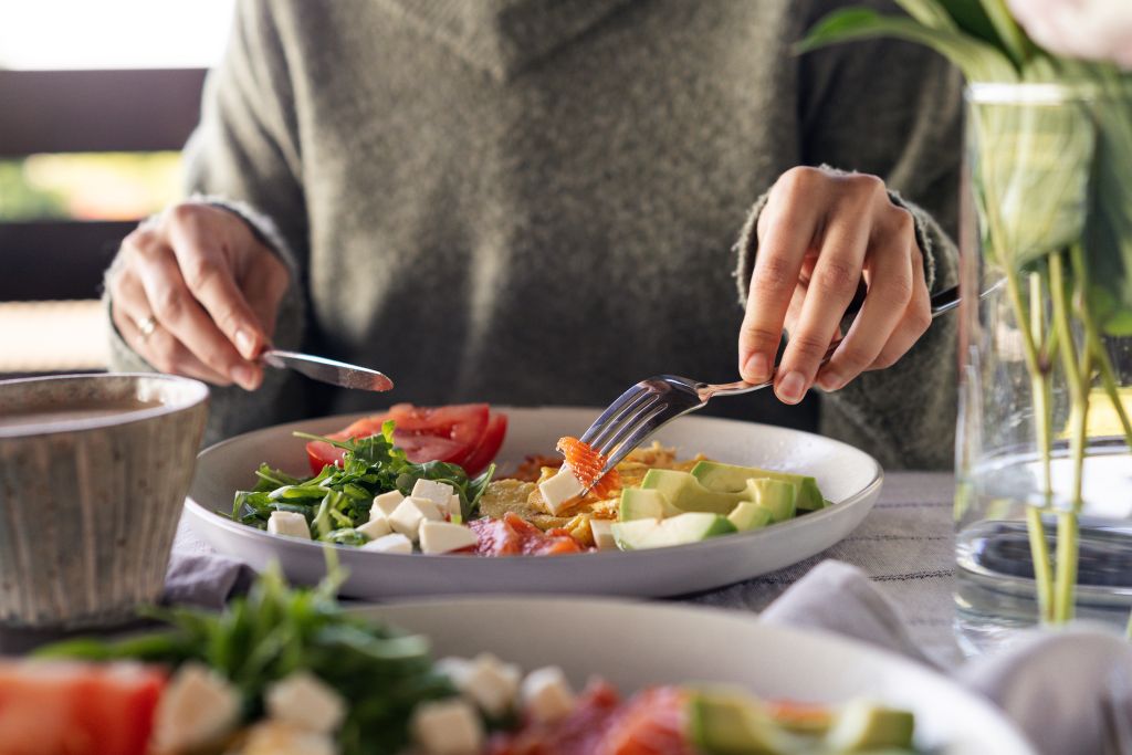 Woman eating healthy keto salad