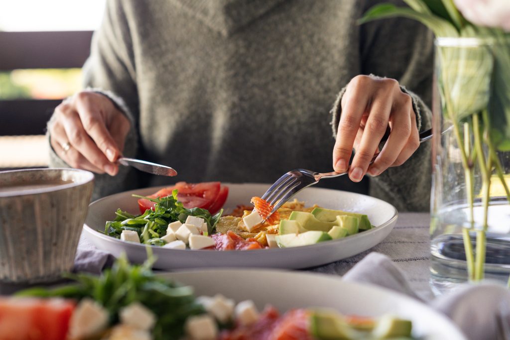 Woman eating healthy keto salad