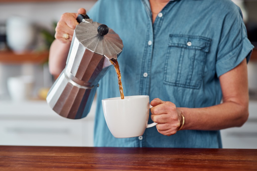 Woman pouring black coffee