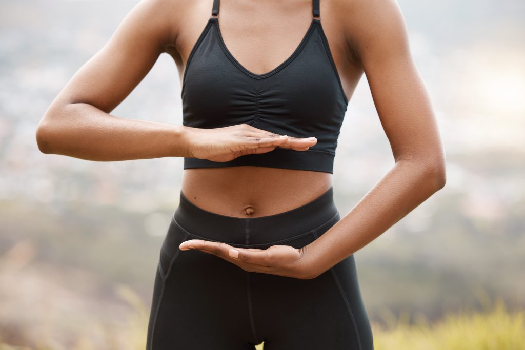 Woman holding hands on stomach