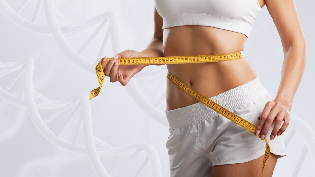 Young woman measuring her waist