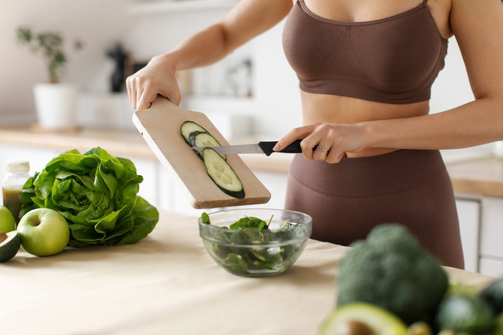 Woman cutting cucumber and the benefits of cucumber