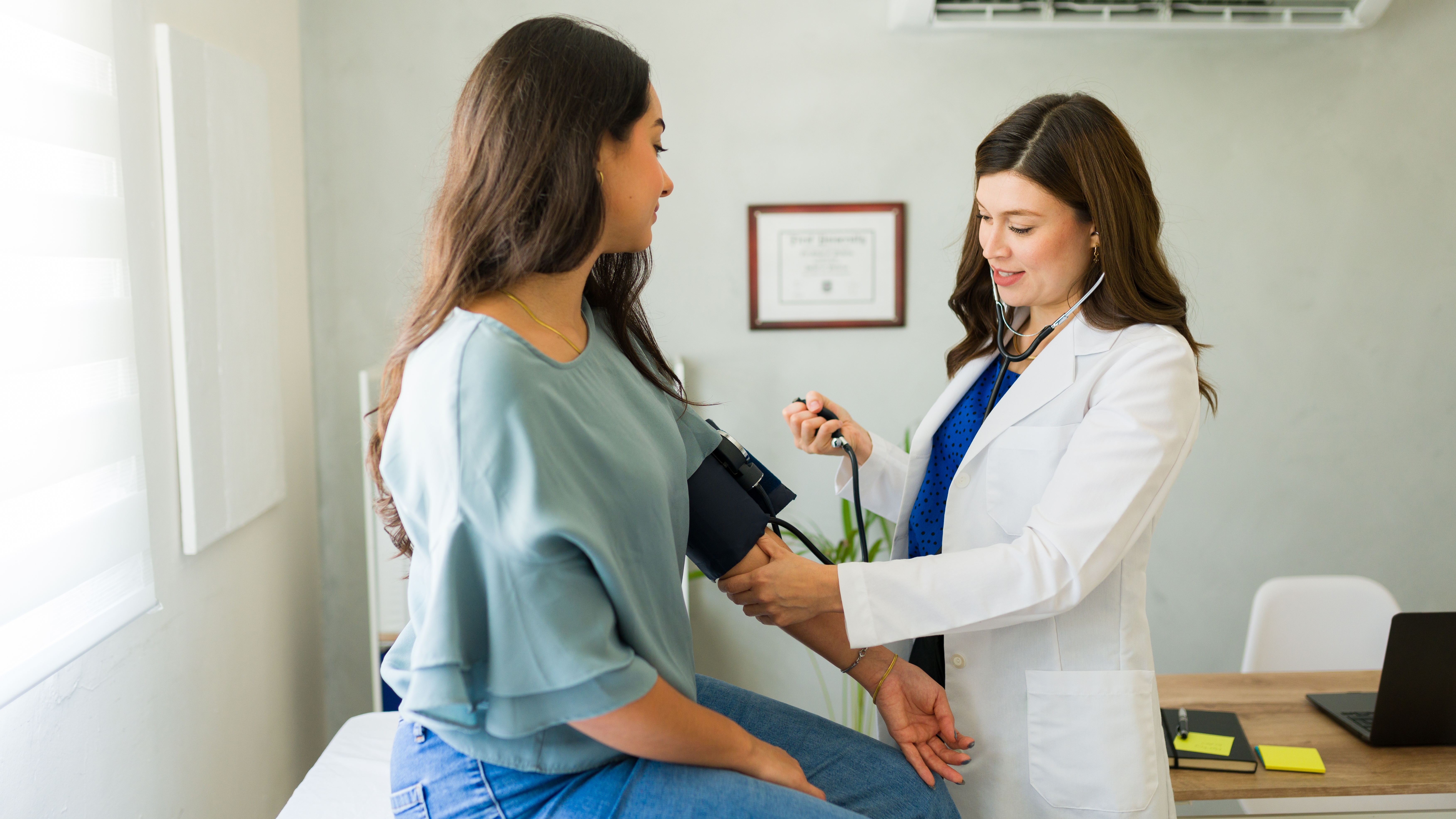 Doctor checking blood pressure