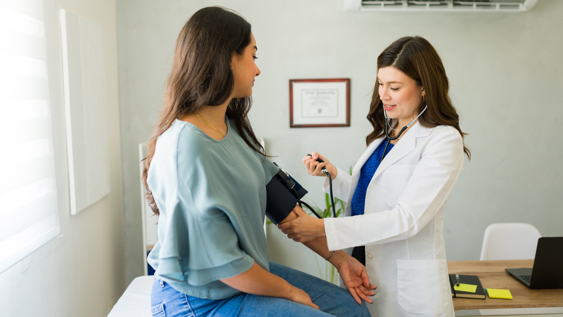 Doctor checking blood pressure
