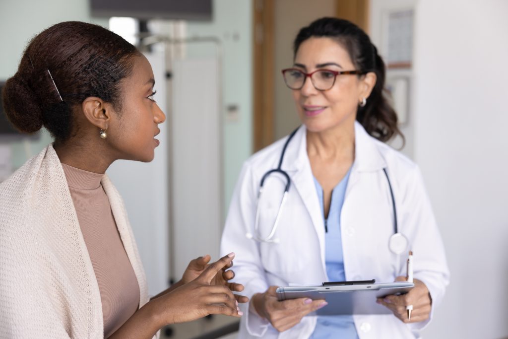 Woman talking to doctor