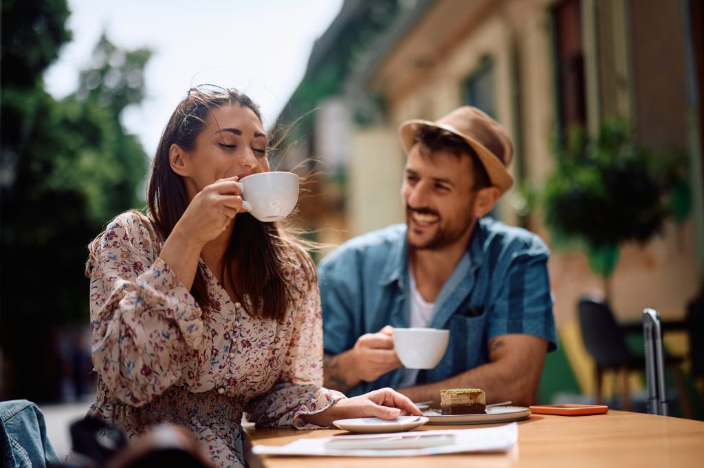 Young Couple Enjoying In Sidewalk Cafe