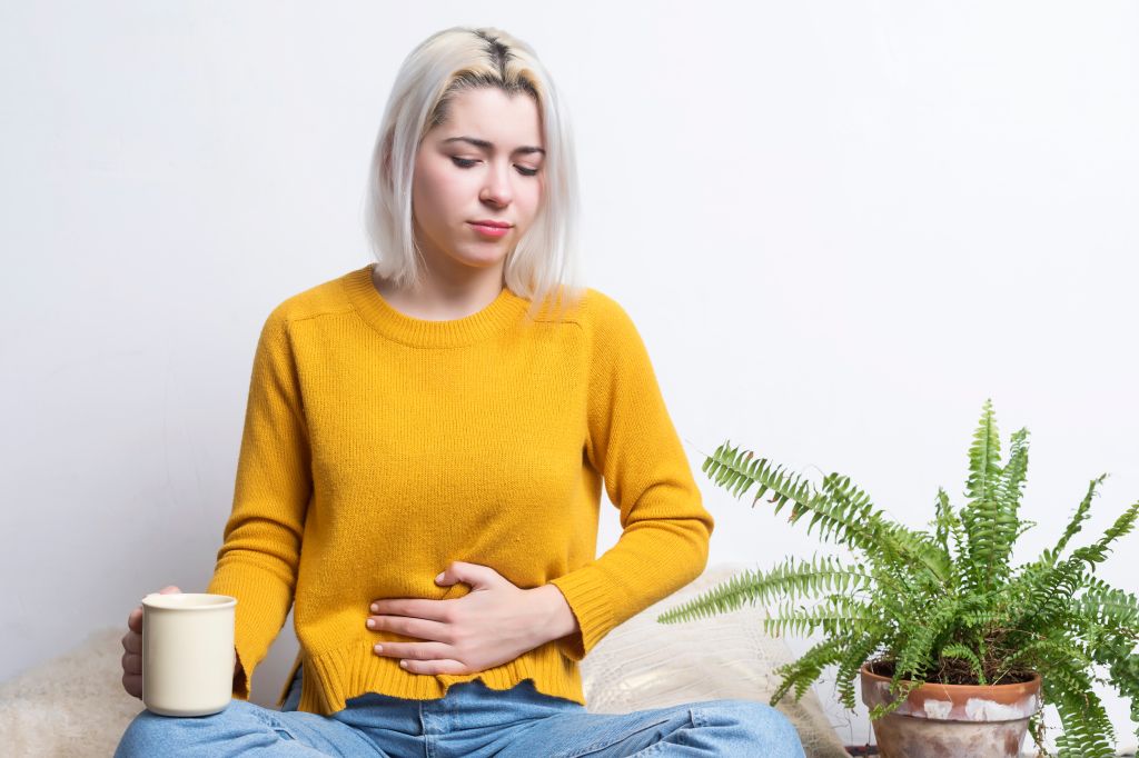 Woman putting a hand on her stomach