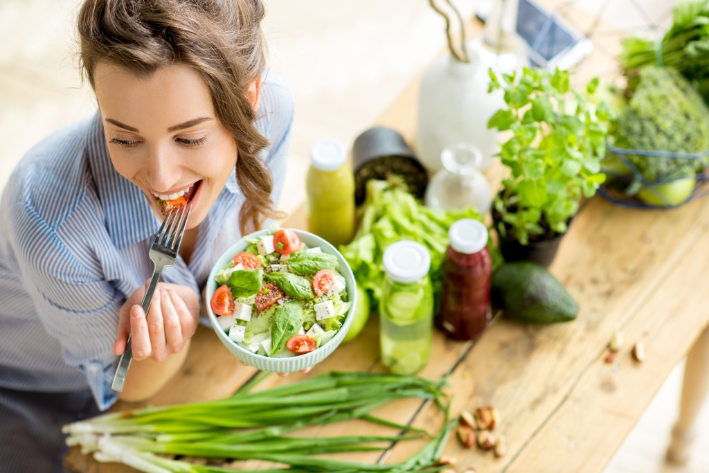 Woman eating vegetables