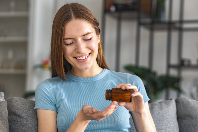 Woman holding a supplement bottle
