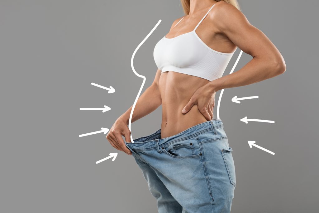 Young woman in big jeans