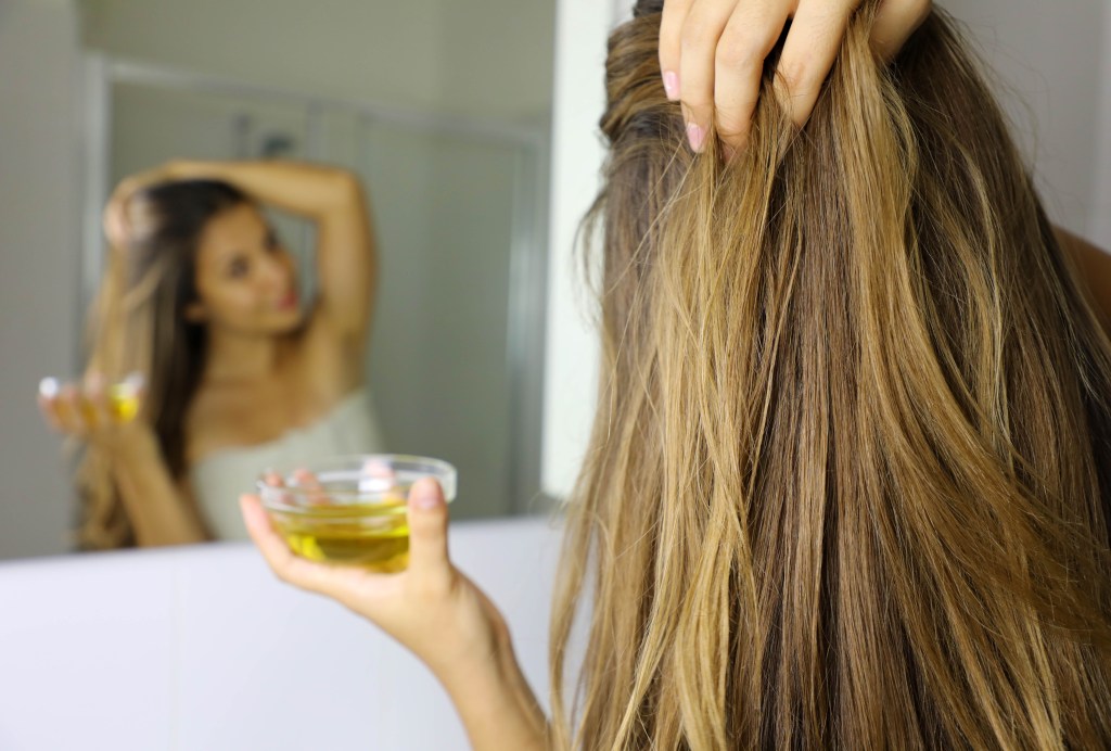 applying olive oil to hair