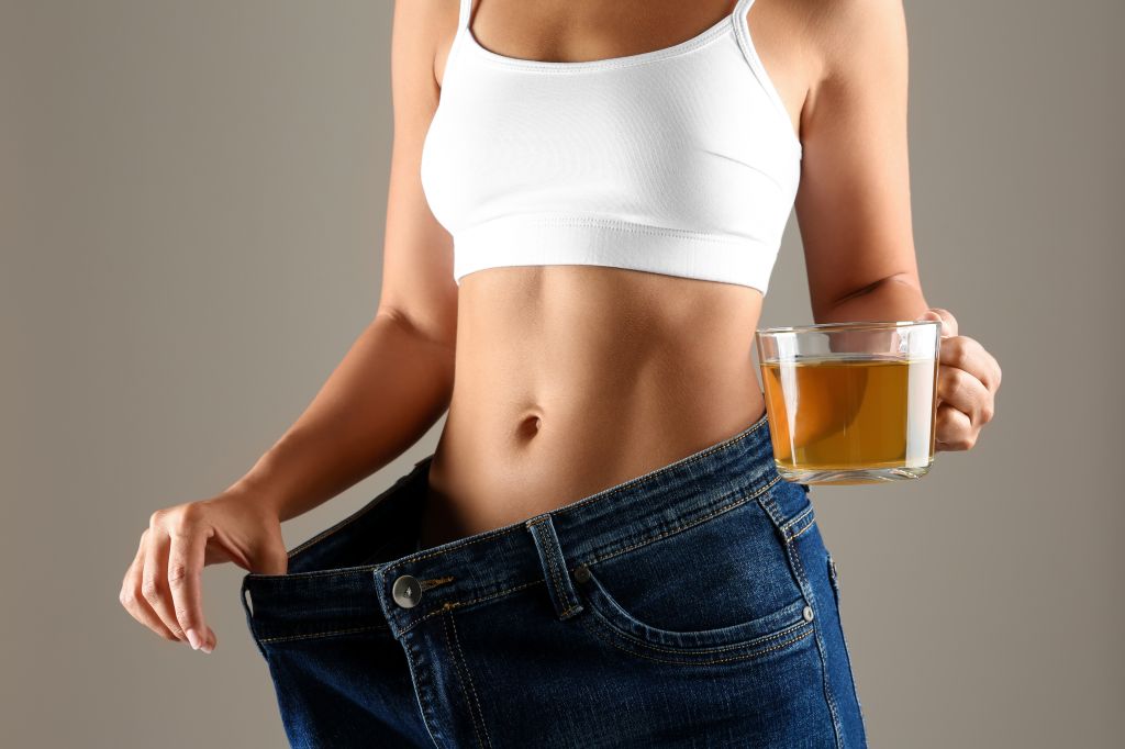 woman losing weight with a cup of tea one of Health Benefits of Green Tea