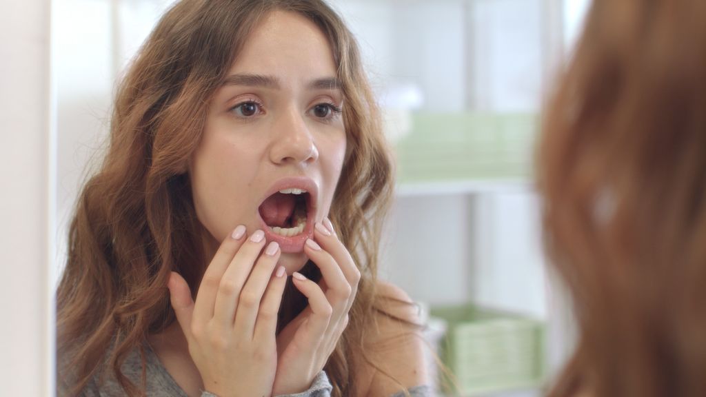 Woman checking her mouth