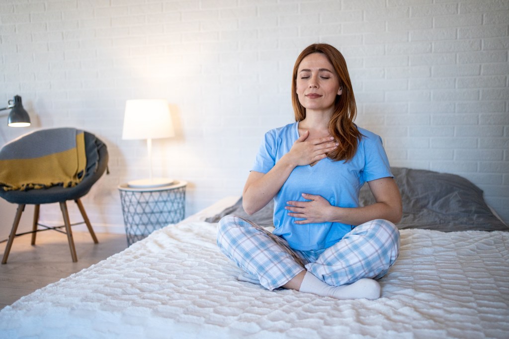 Woman sitting on a bed   