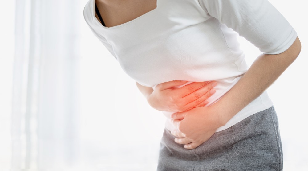 Woman with stomach pain the Side Effects of Tums