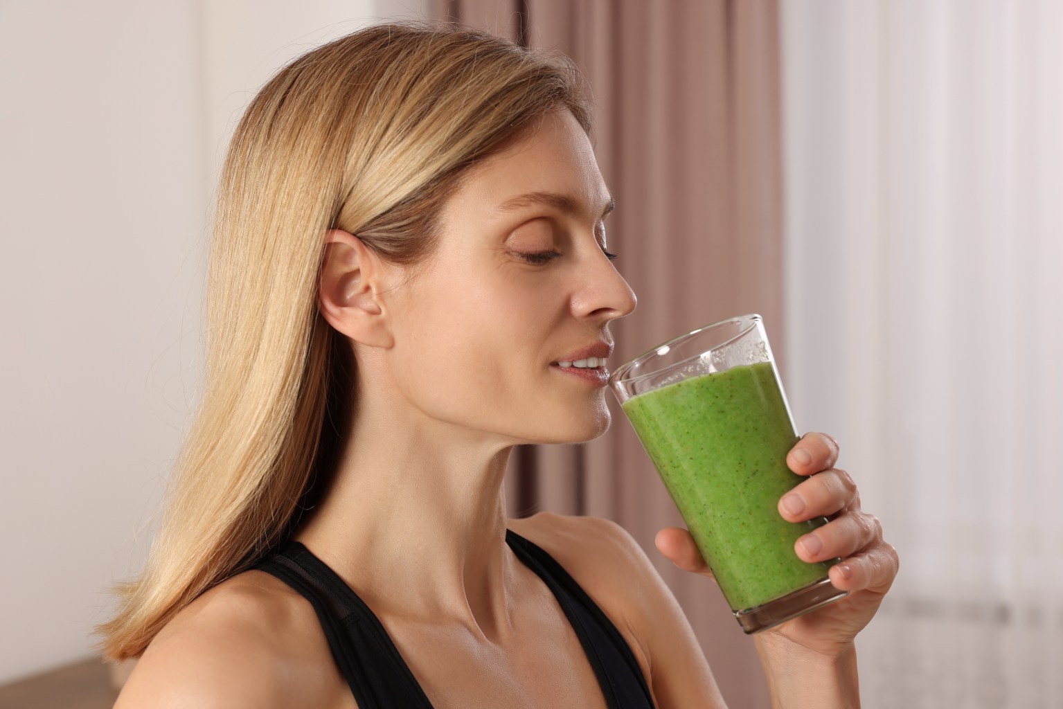 Woman drinking kale shake 