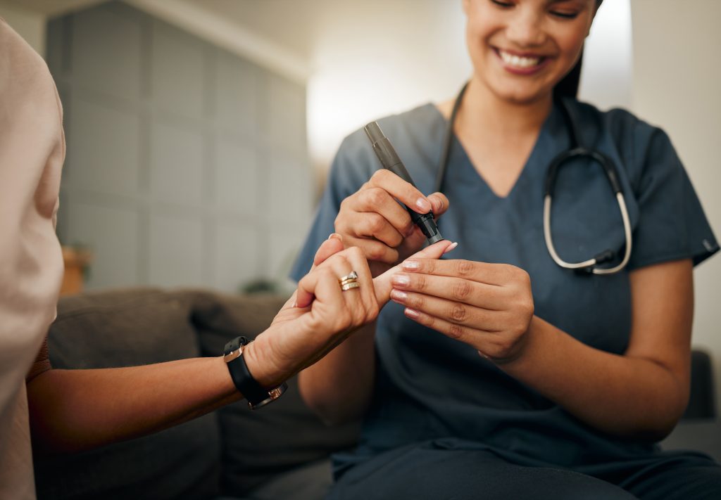 Doctor testing blood sugar levels