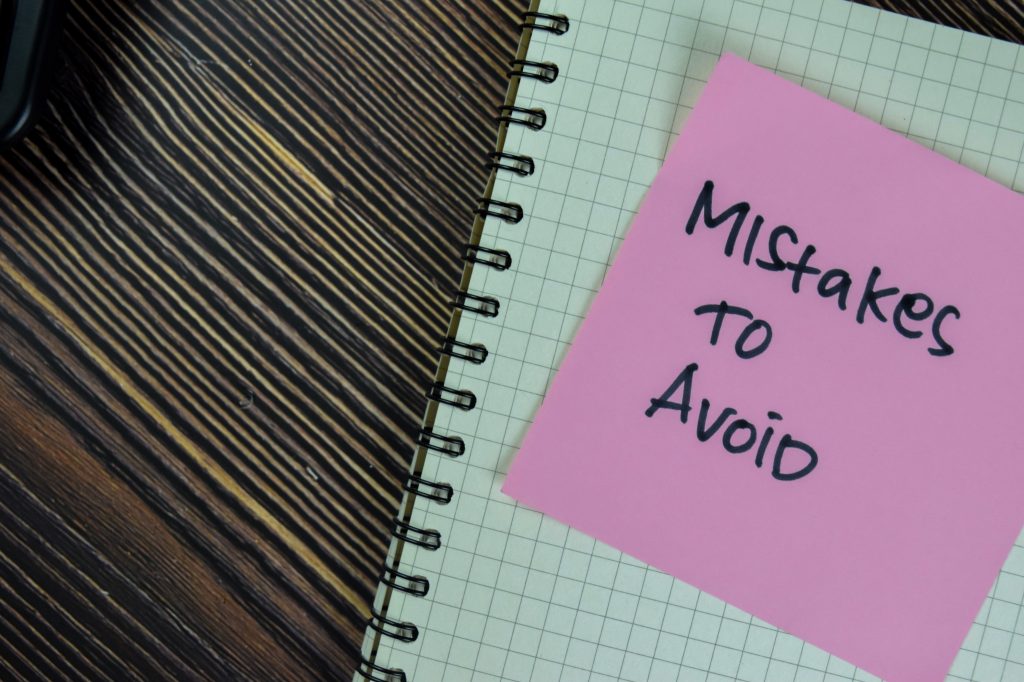 Mistakes to avoid written on a Post-it note