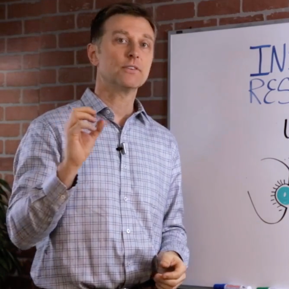 Dr Berg presenting in front of whiteboard