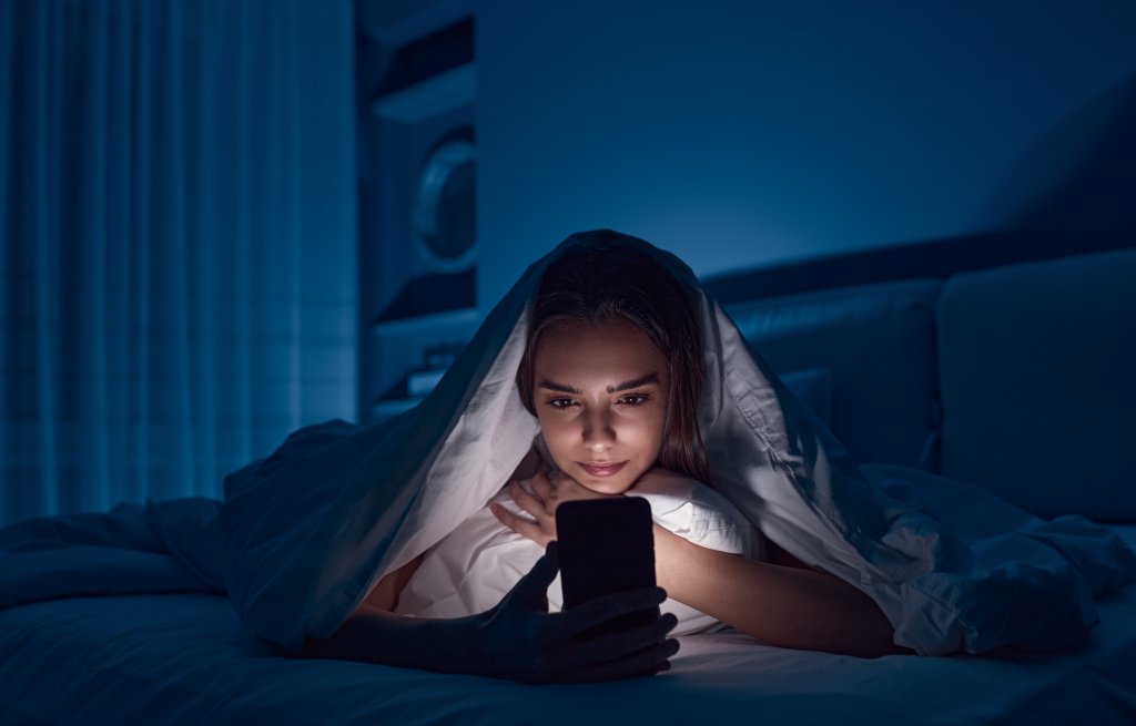 Woman using a cellphone before bed