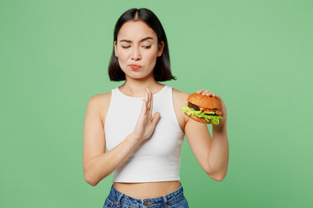 Woman refusing a burger