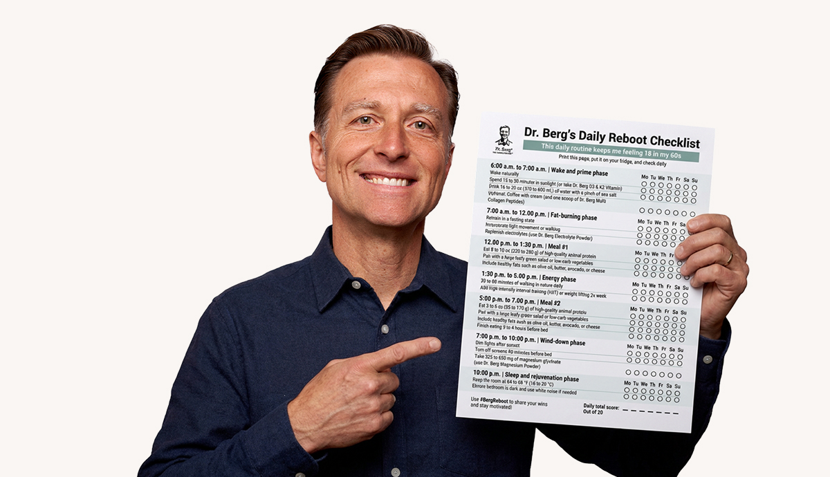 Dr. Berg holding a checklist