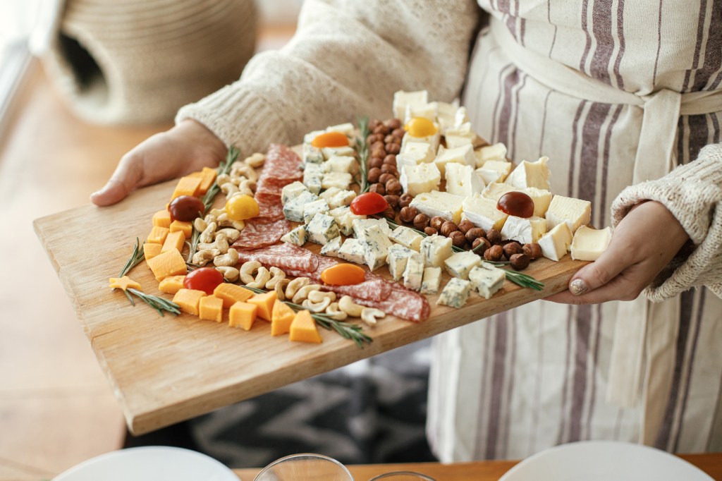 woman holding cheeseboard