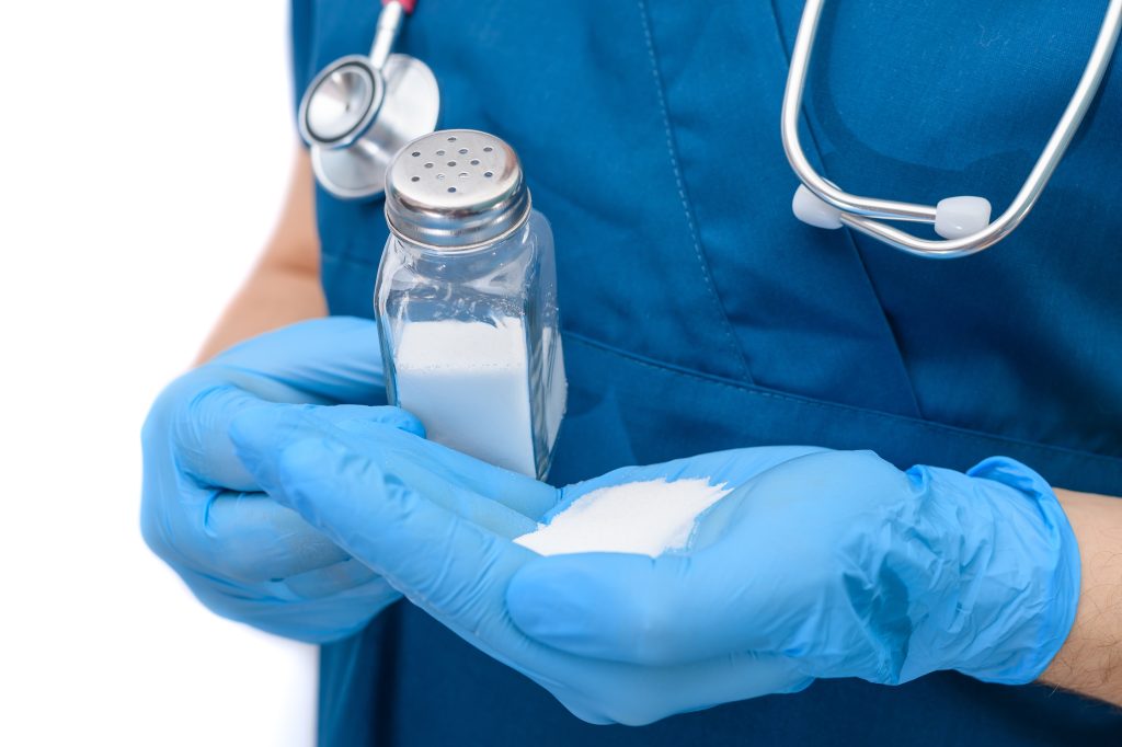 Doctor pours salt on hand