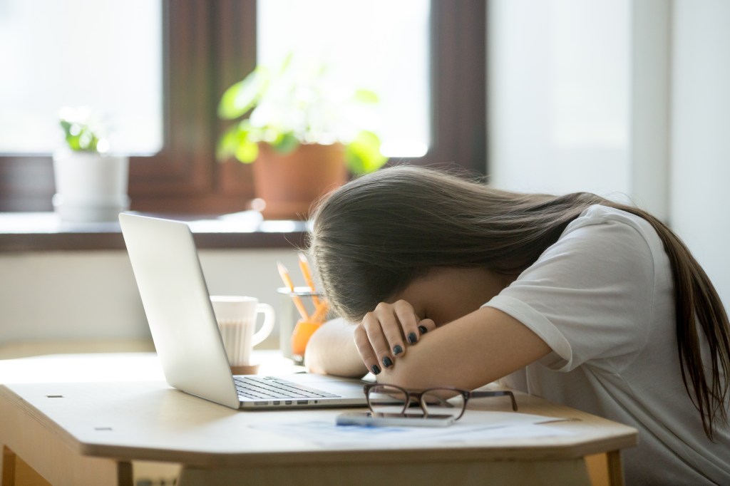 Tired woman at desk