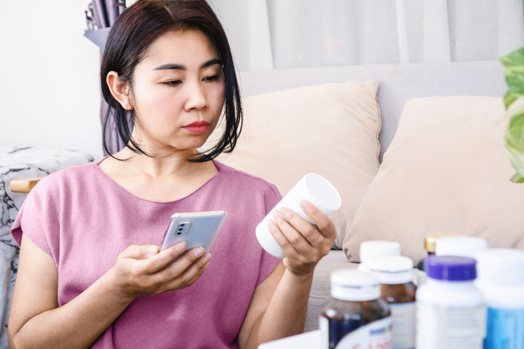 Woman reading supplement labels 