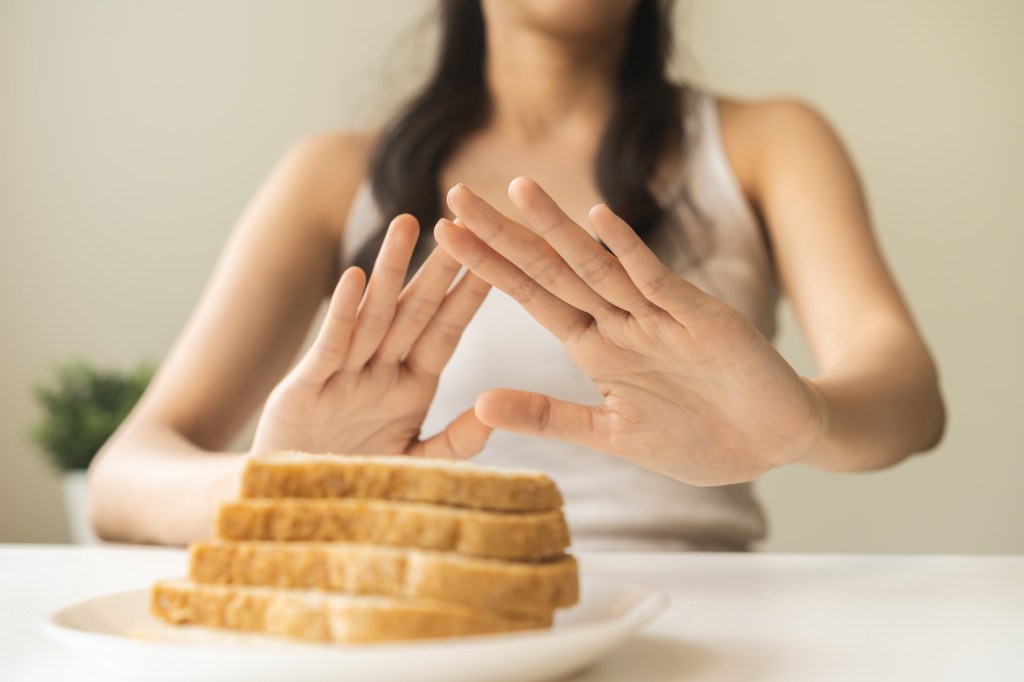 Woman declicing bread    

