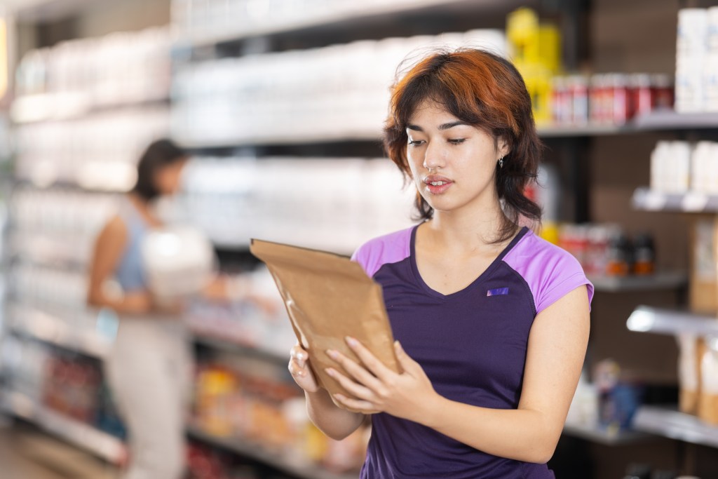 Woman reading supplement facts