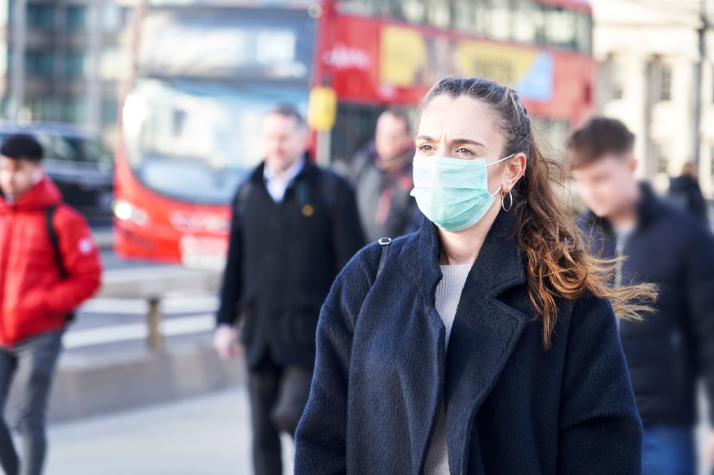 Woman walking in a polluted city
