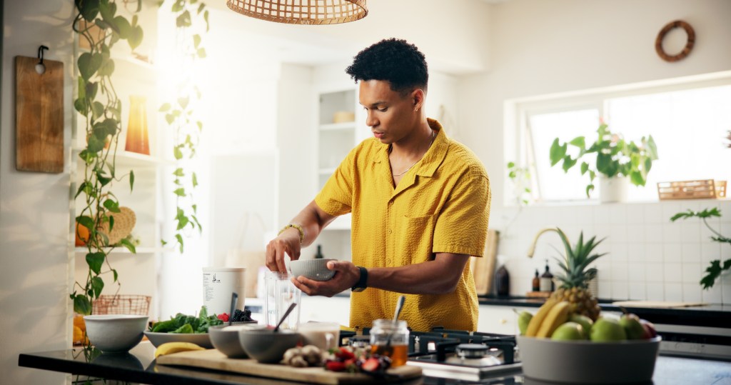 Young man cooking at home  