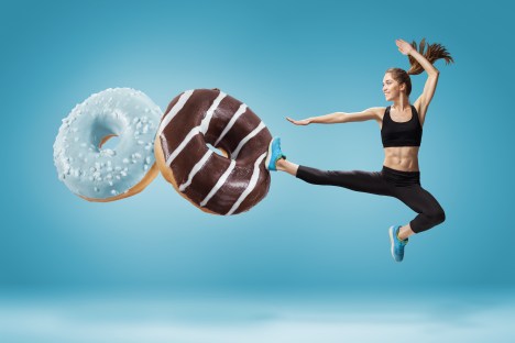Woman kicking donuts 