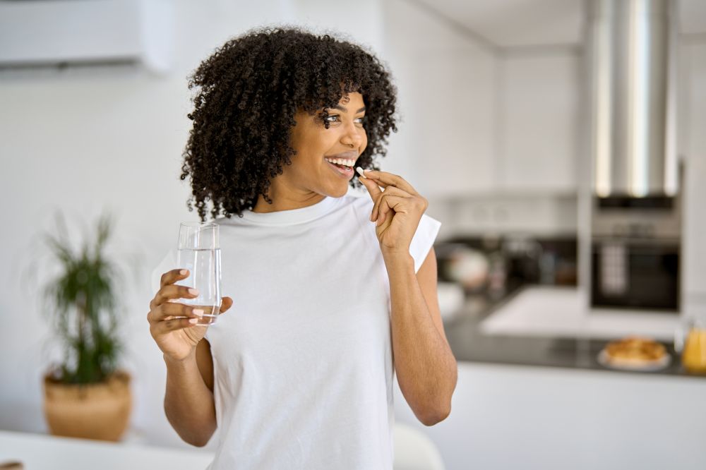 Woman taking a supplement