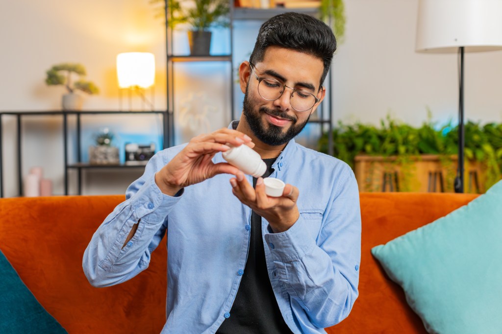 Man taking a supplement  