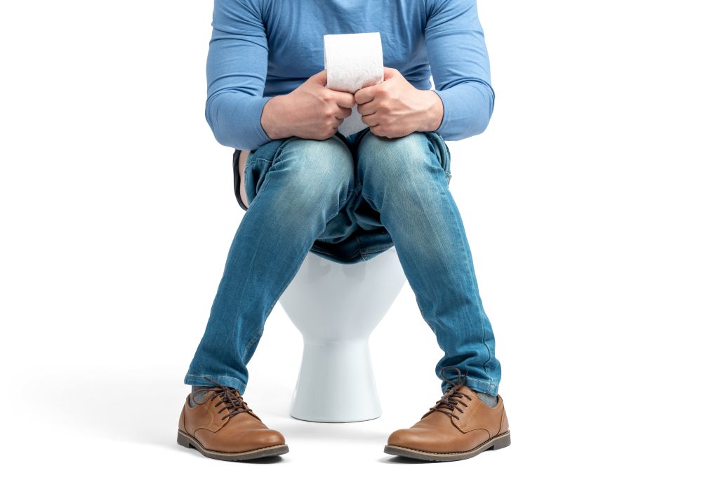 Man on toilet with diarrhea