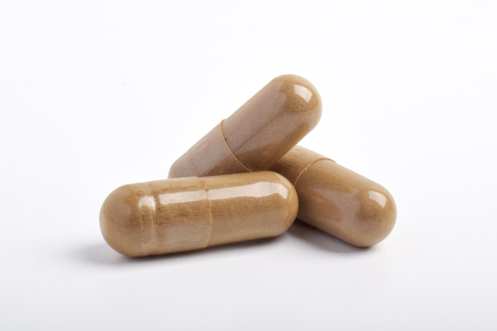 Pile of vitamin capsules isolated on white background