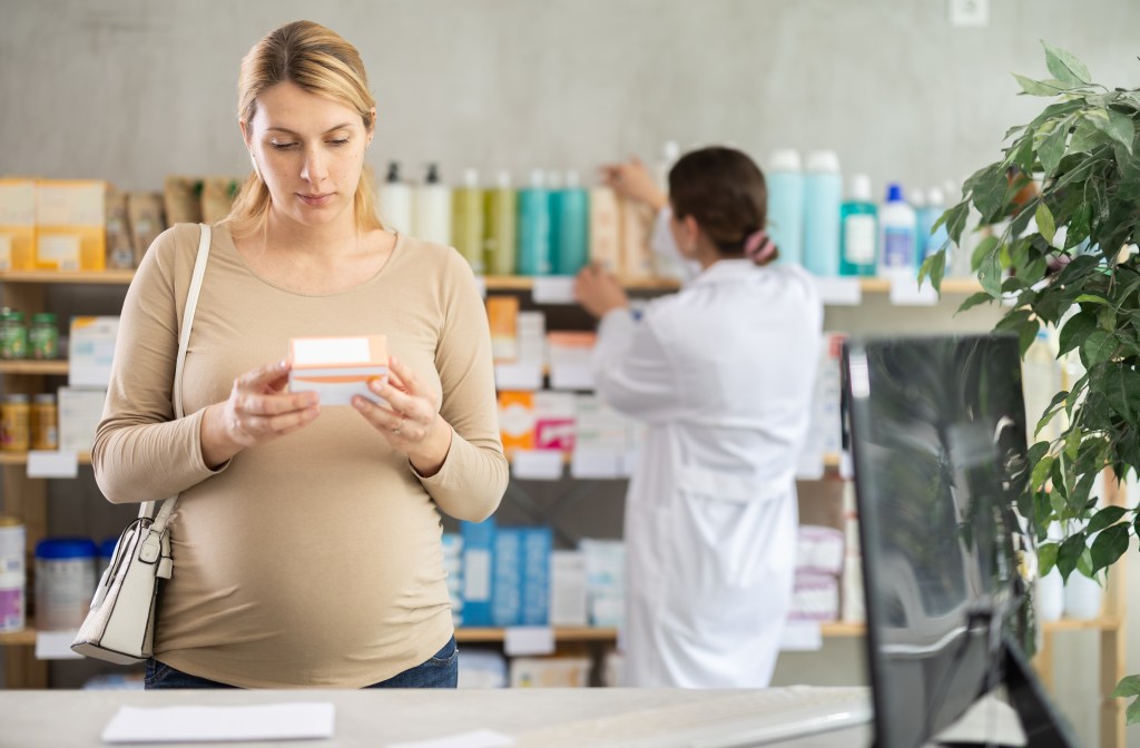 Woman choosing a supplement 