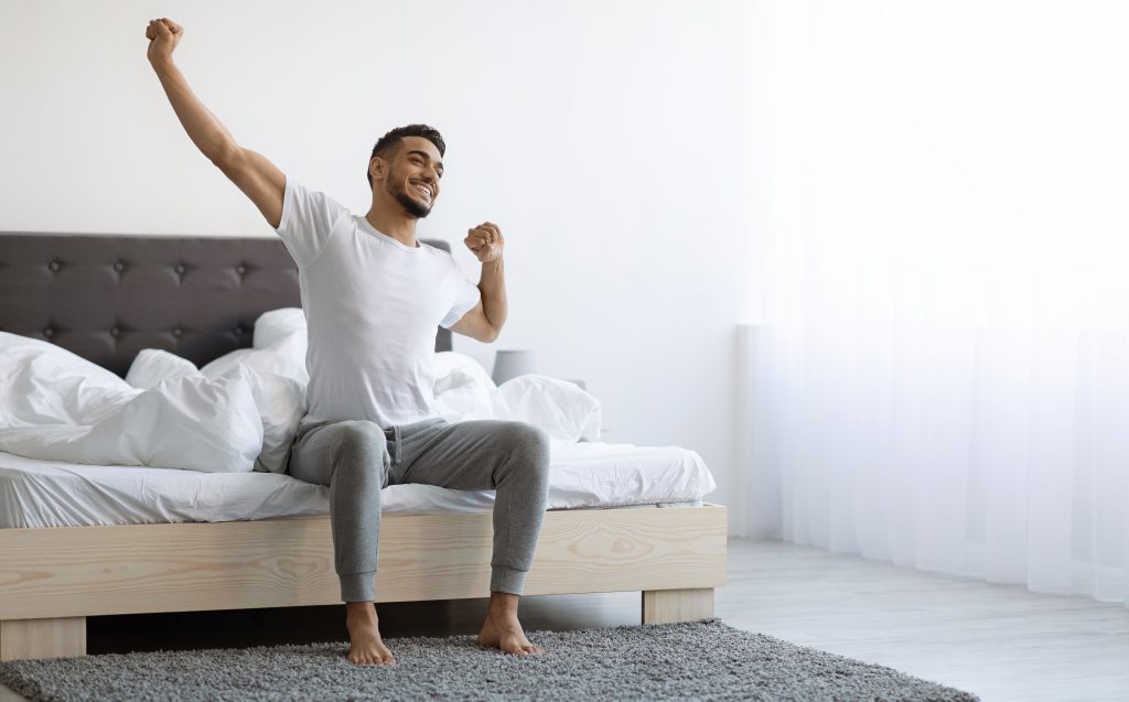 Refreshed man waking up 