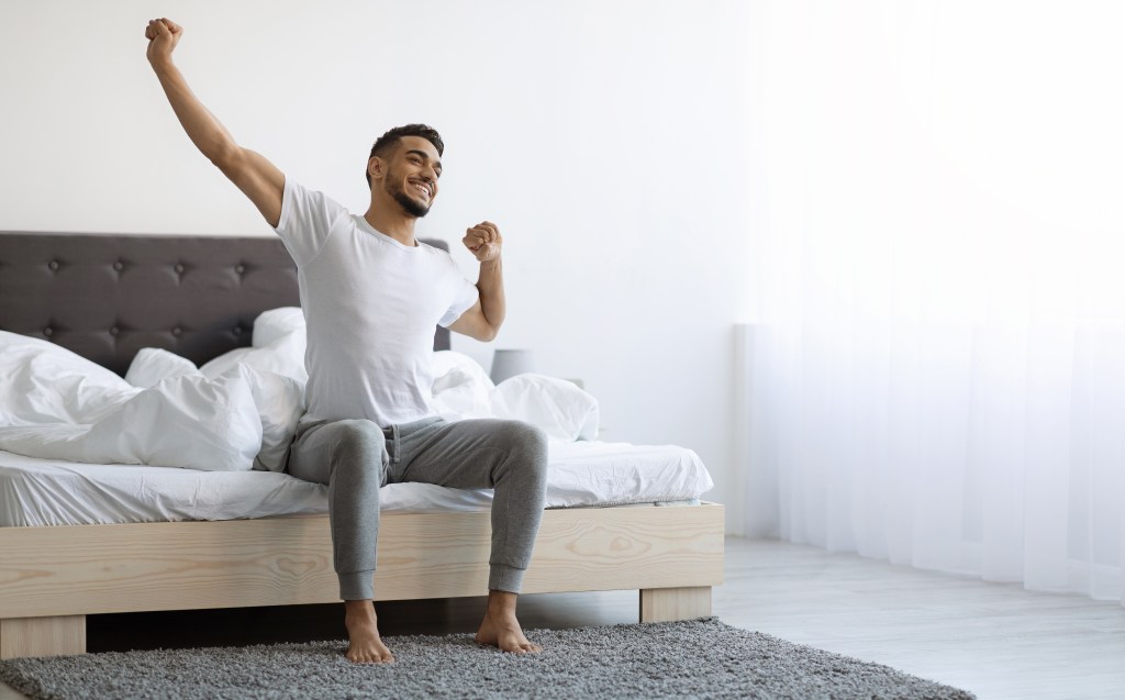 Refreshed man waking up 