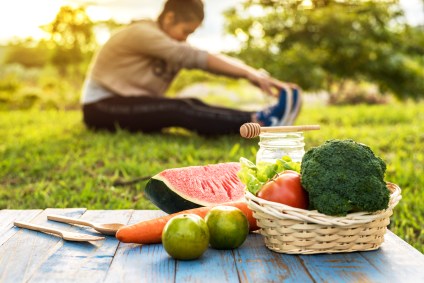 Woman ignoring food while stretching
