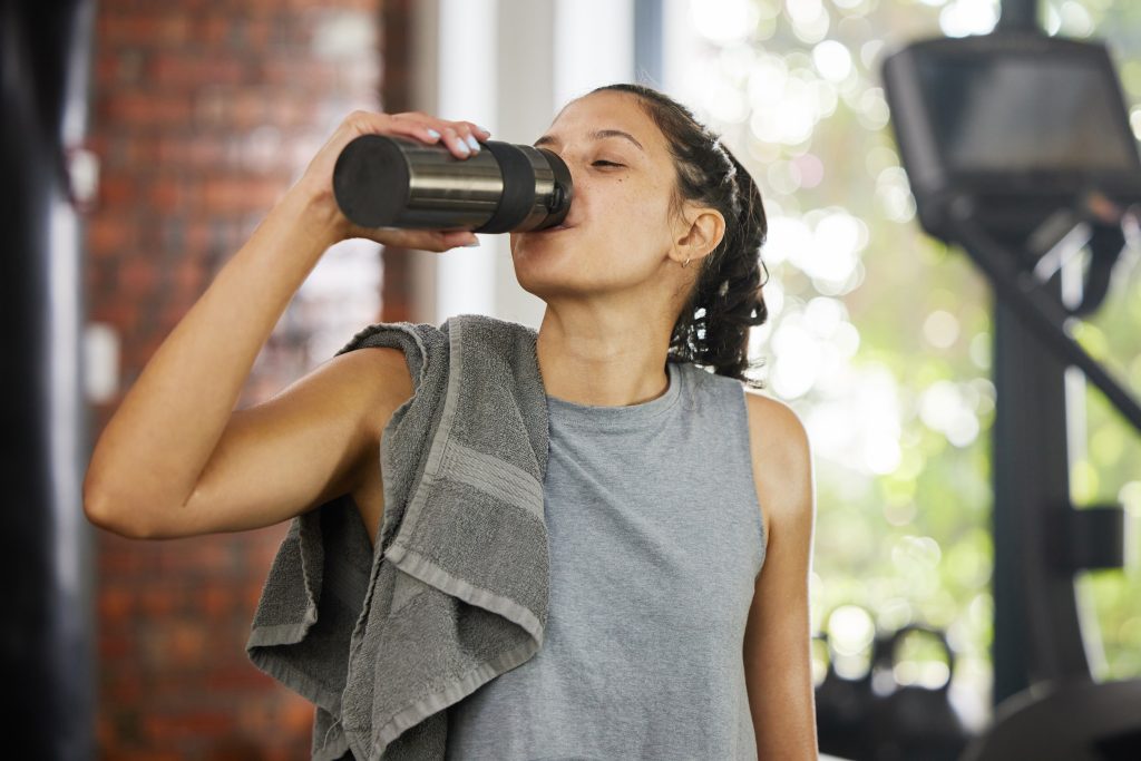 Athletic women drinking from bottle
