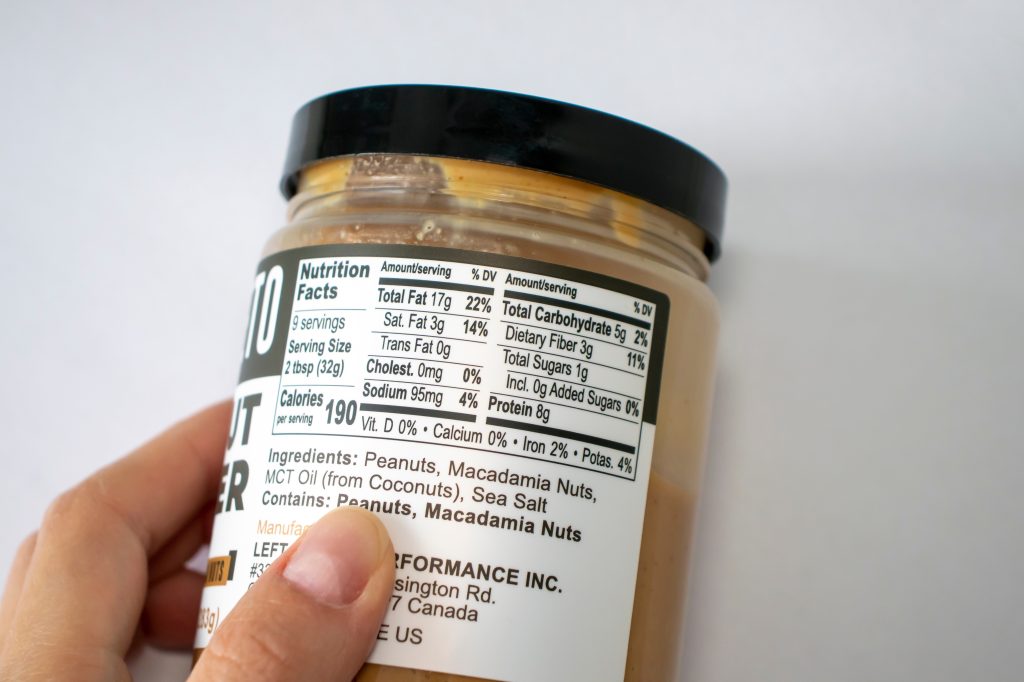 Person inspecting the nutrition and ingredients label