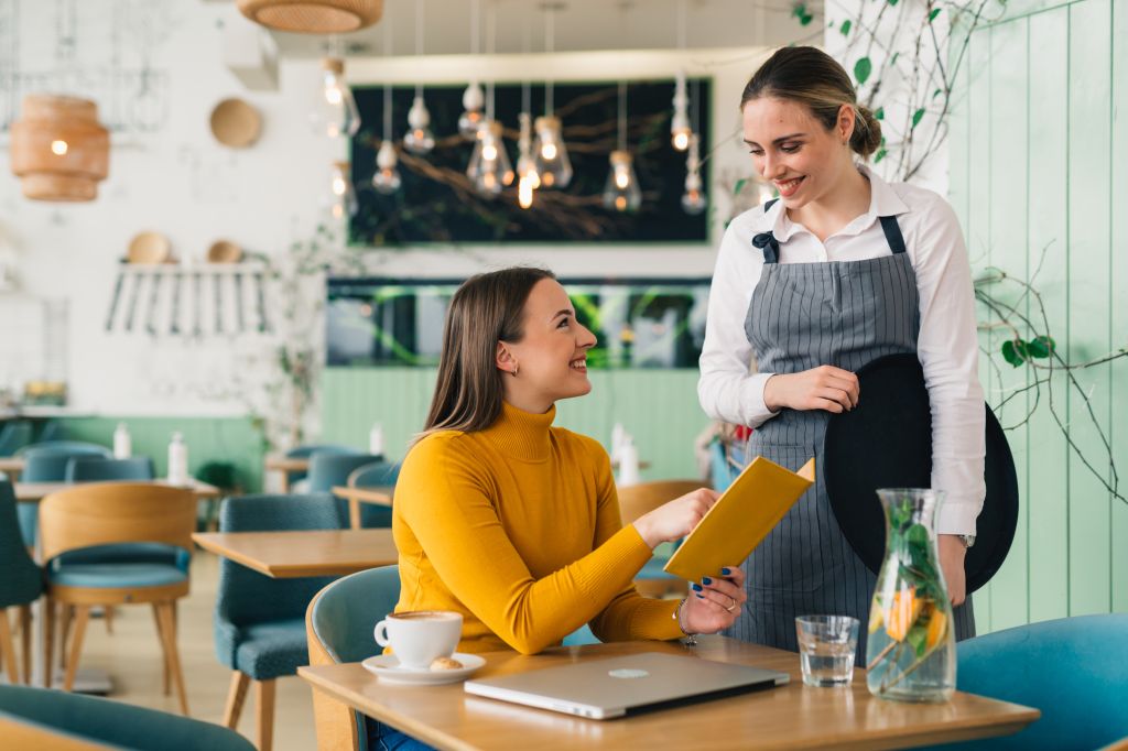 Woman asking server a question
