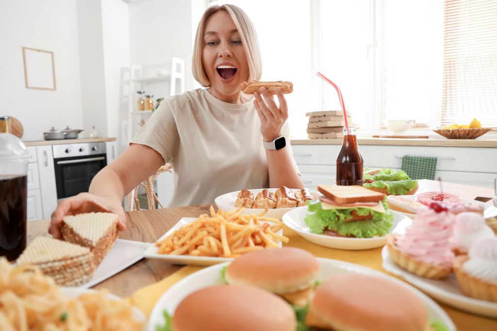 Woman eating unhealthy foods