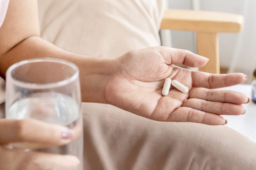 Hand holding capsules