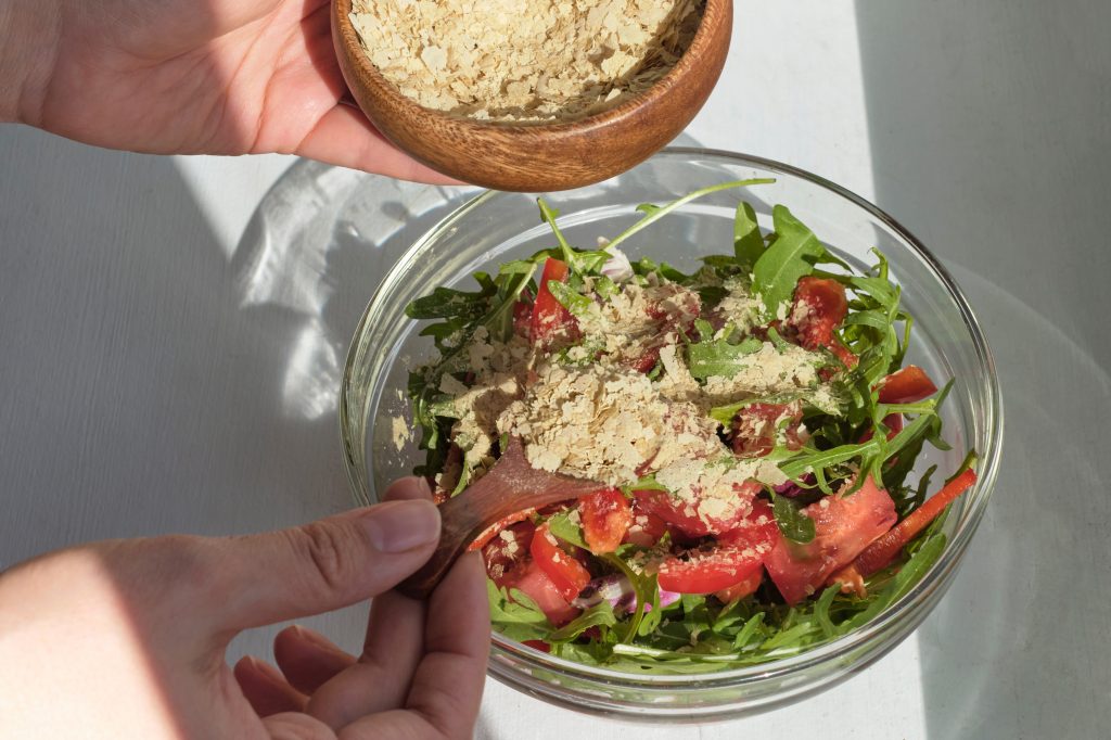 Sprinkling yeast on a salad