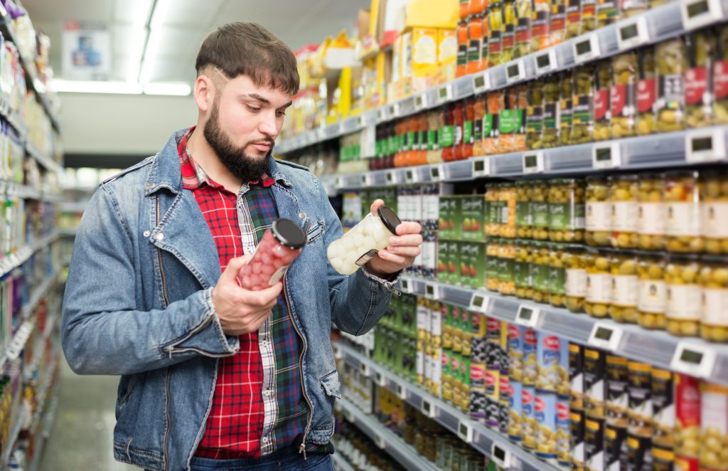 Man checking a label for seed oil